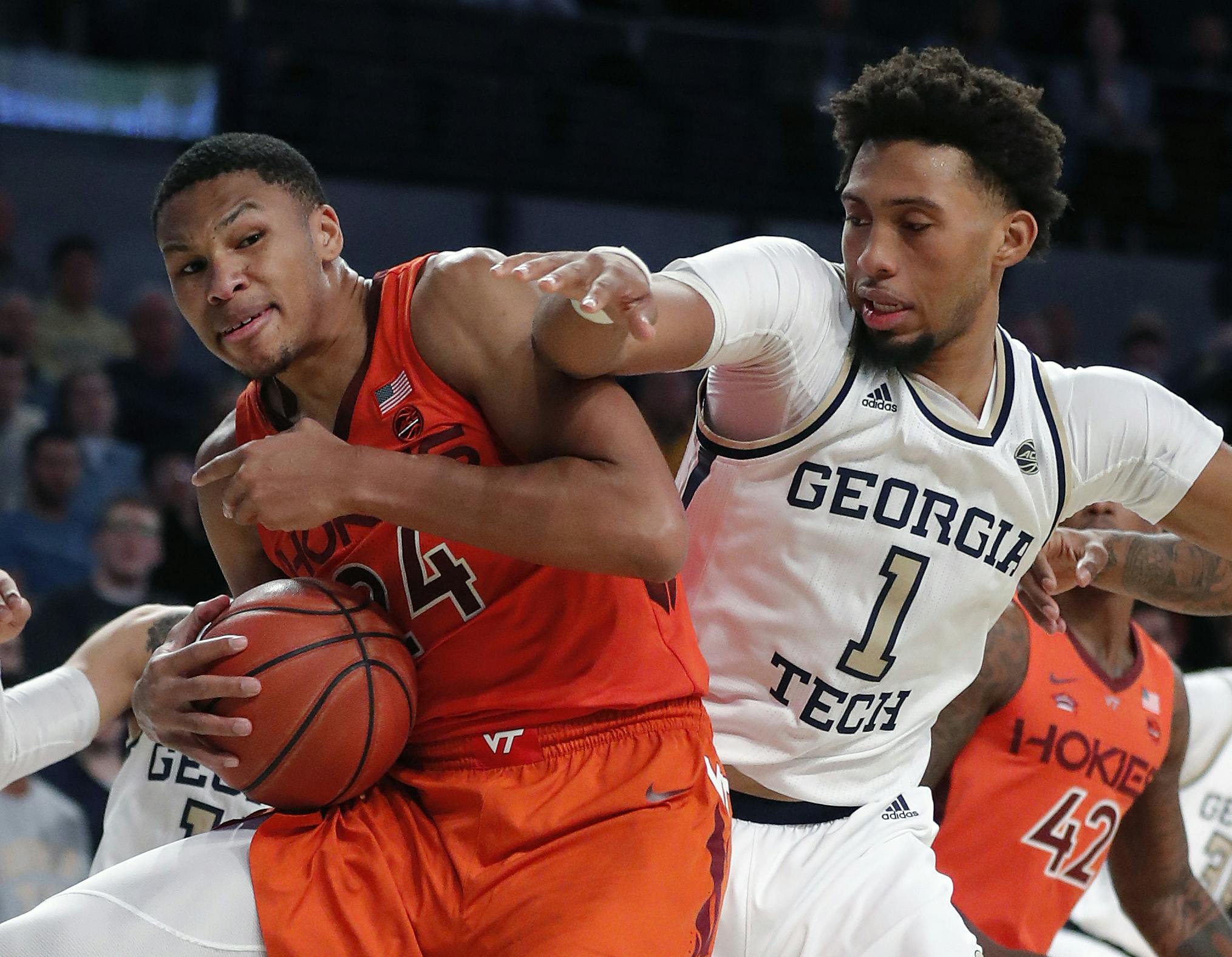 Virginia Tech forward Kerry Blackshear Jr. (24) and Georgia Tech forward James Banks III (1) vie for a rebound during the second half of an NCAA college basketball game in Atlanta.