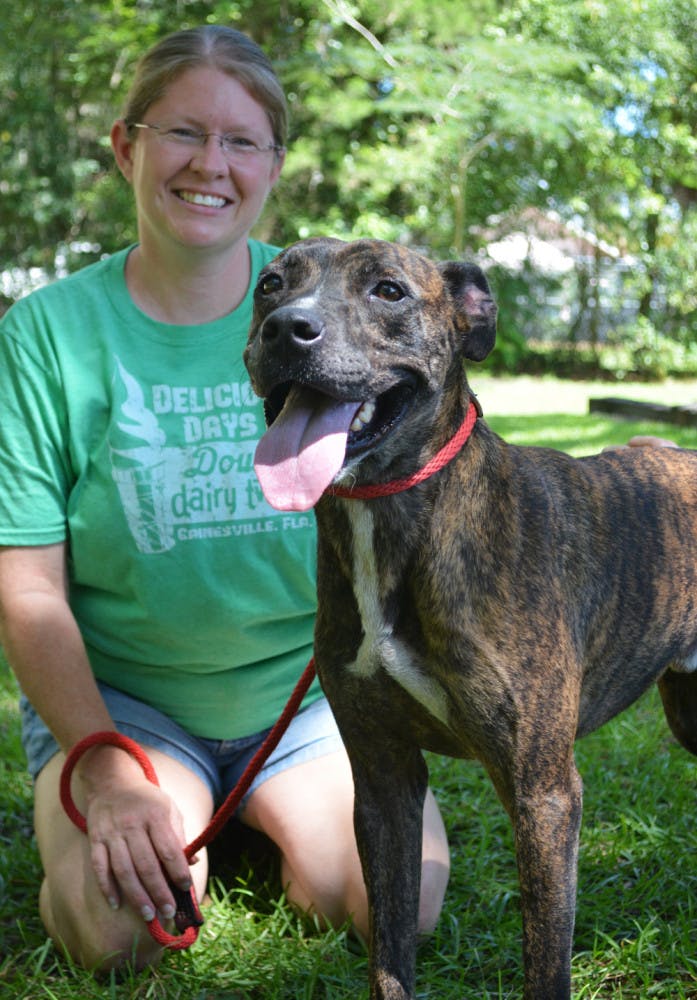 Aspen stands next to Michelle Dunlap, 40, director of Phoenix Animal Rescue, at West End Animal Hospital in Newberry on Wednesday. Aspen is up for adoption. 