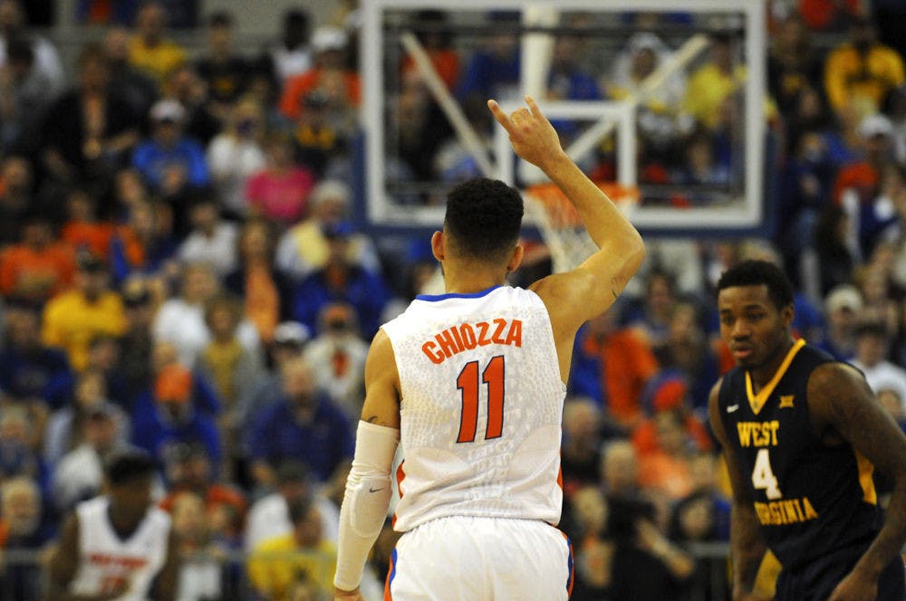 <p>Chris Chiozza signals a play as he drives down the court during Florida’s win over West Virginia on Jan. 30, 2016, in the O’Connell Center.</p>