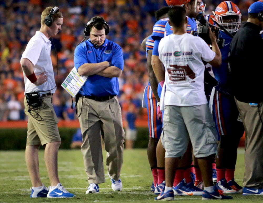 <p>Florida head coach Will Muschamp paces on the field during Florida's 30-27 loss to LSU on Saturday at Ben Hill Griffin Stadium.</p>