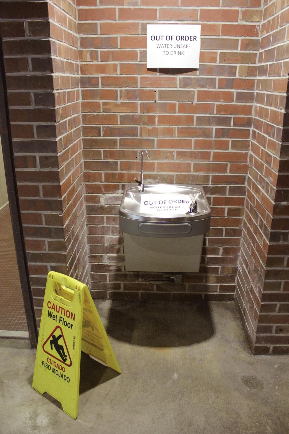 <p>A water fountain in the east wing of Norman Hall is marked as out of order on Sept.17, 2015. Water in some parts of the building was deemed unsafe to drink.</p>