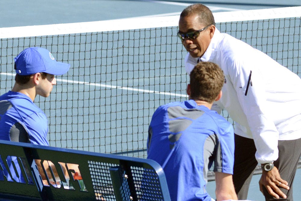Coach Bryan Shelton talks with sophomores Elliott Orkin and Maxx Lipman during Florida's 9-3 win against William &amp; Mary on Jan. 10 at the Ring Tennis Complex.