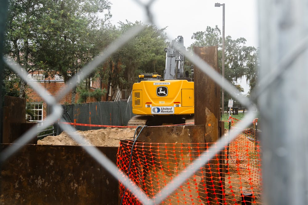 <p>An unoperated crane sits behind Marston Science Library in a fenced off construction zone on Friday, Sept. 13, 2024. </p>