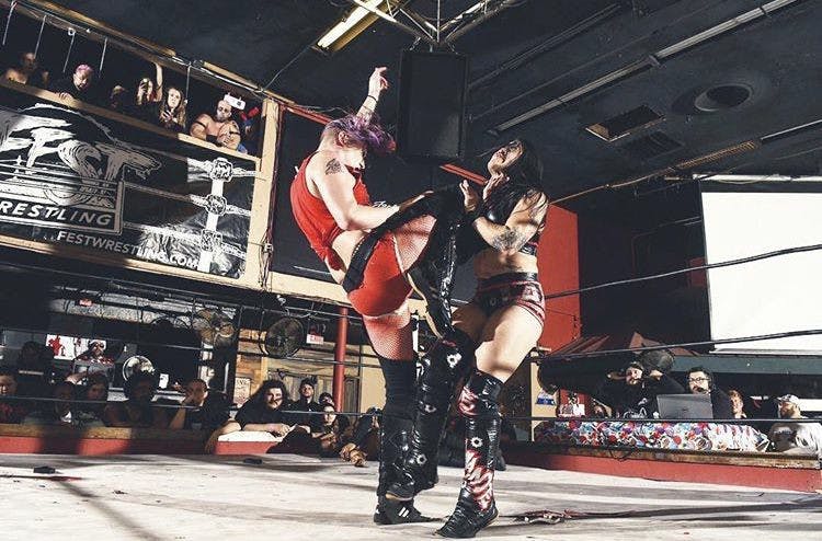 Two wrestlers battle at the FEST: We Are Family wrestling event in 2018.