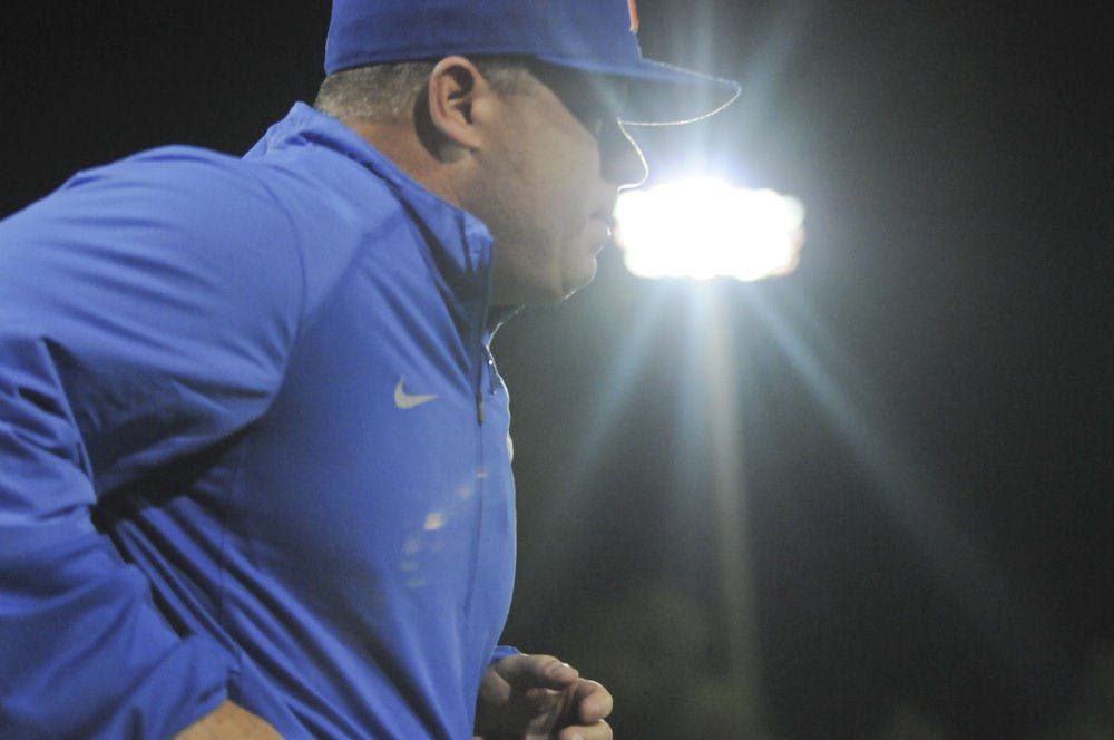 <p>UF coach Kevin O'Sullivan runs out of the dugout during team introductions prior to Florida's 4-2 season-opening win on Feb. 19, 2016, at McKethan Stadium.</p>