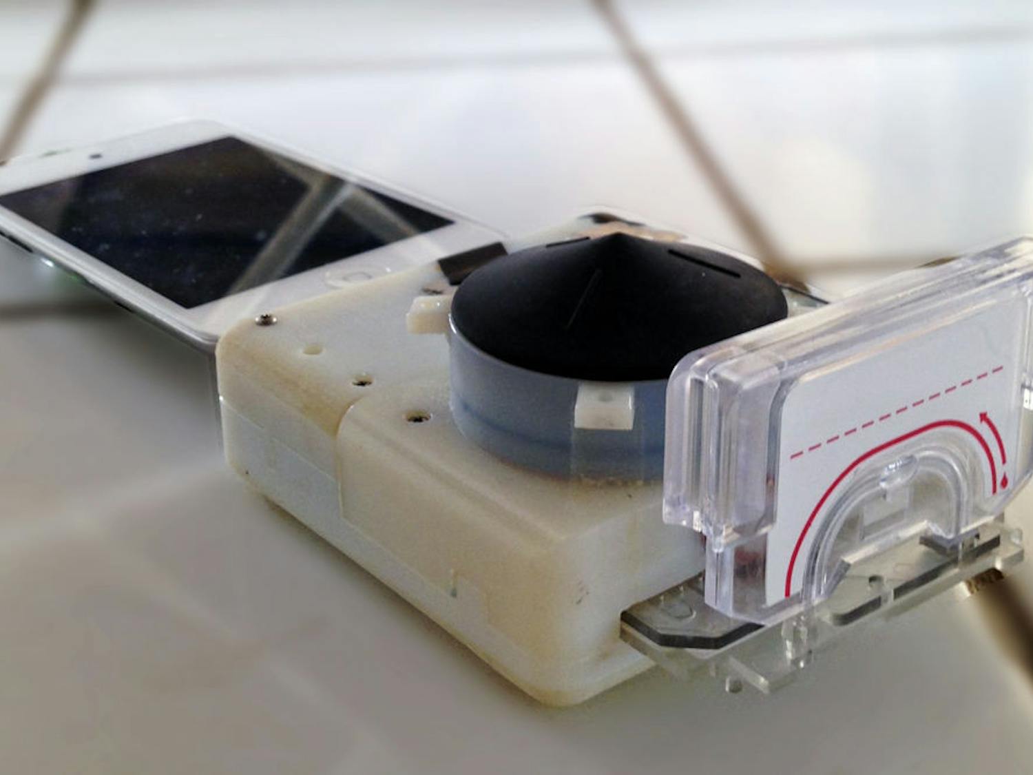 Pictured is one of the smartphone dongles that can test for HIV and syphilis. Funded by the Saving Lives at Birth program through the U.S. Agency for International Development, the device costs $34 to make, plus $2 for each test cassette.
