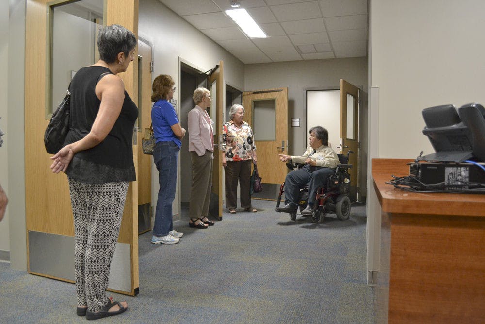 Rick Nelson (right), 57, advisor and educational training specialist at the Disability Resource Center, explains the functions of testing rooms to visitors during the DRC open house event at Cypress Hall Aug. 26, 2015.