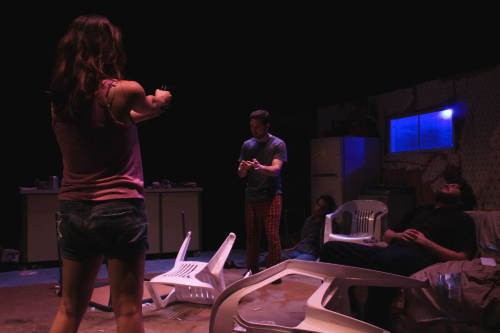 Dottie Smith, played by Debbie Maciel, stands ready to shoot killer Joe, played by Michael Pamberton. 