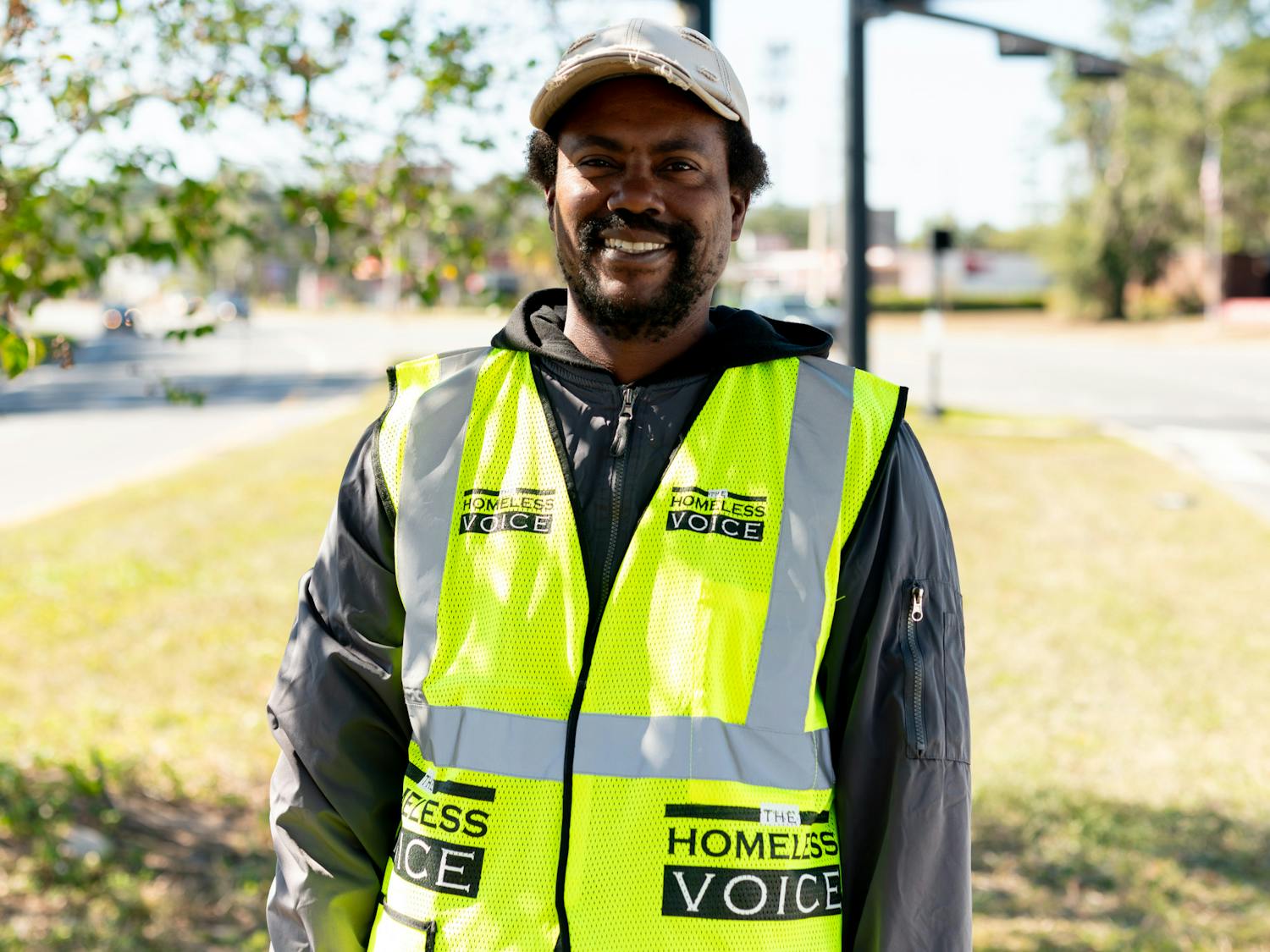 Thaddeus Bastian stands near UF Small Animal Hospital distributing The Homeless Voice, a newspaper about homelessness issues on Sunday, Nov. 5, 2023.