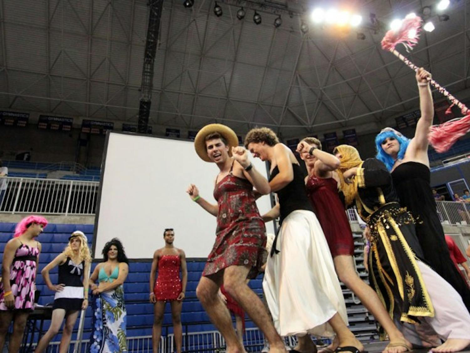 Participants of the Mr. Relay Pageant dance on stage in the Stephen C. O'Connell Center while waiting for the results of the fundraising contest. The men dressed in drag raised over $800 for Relay for Life.