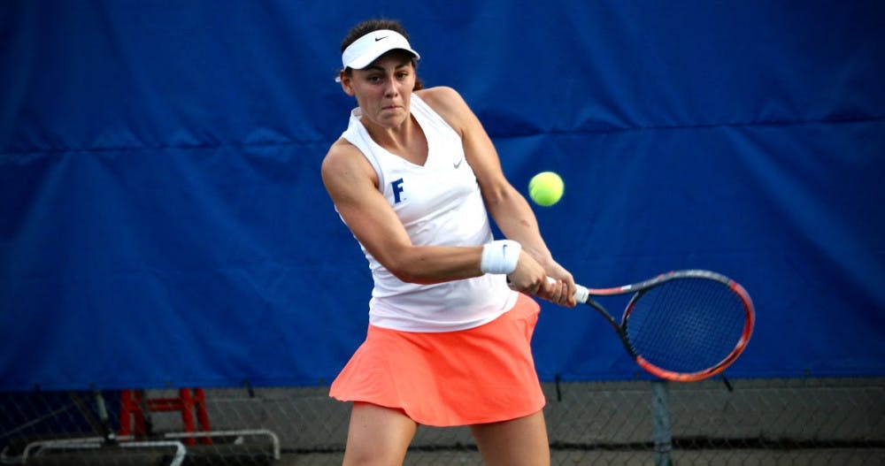 <p>UF's Ingrid Neel hits a backhand during Florida's 4-2 win against Oklahoma State   on Feb. 18, 2017, at the Ring Tennis Complex. </p>