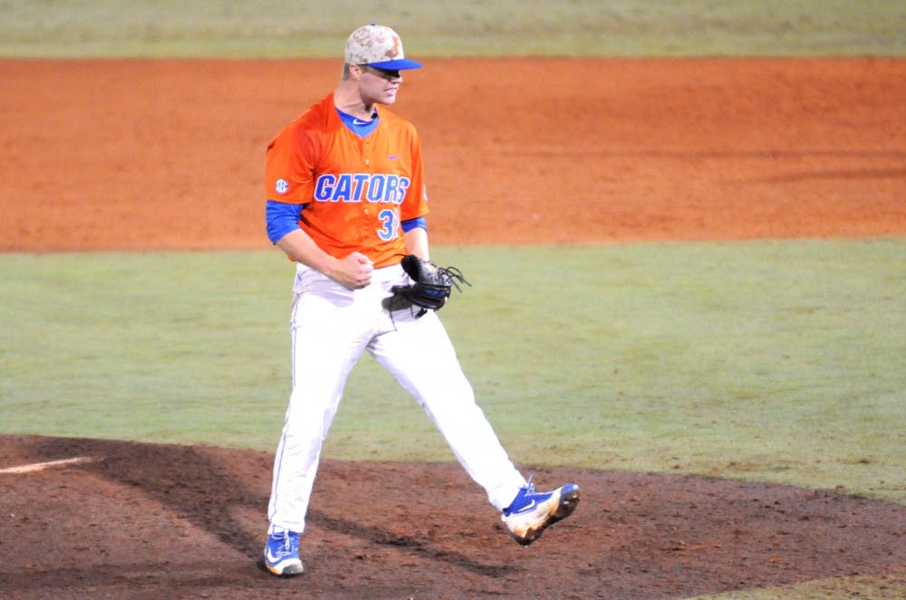 Logan Shore celebrates after throwing a complete-game shutout -- his school-record 13th consecutive win -- during Florida's 6-0 win against Georgia on April 22, 2016, at McKethan Stadium.