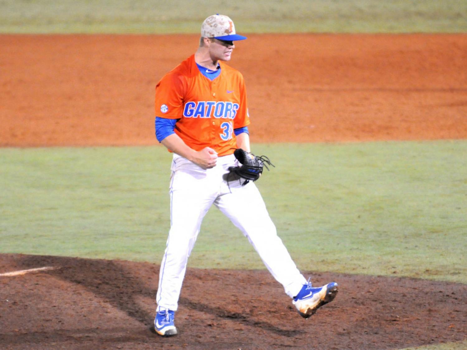Logan Shore celebrates after throwing a complete-game shutout -- his school-record 13th consecutive win -- during Florida's 6-0 win against Georgia on April 22, 2016, at McKethan Stadium.