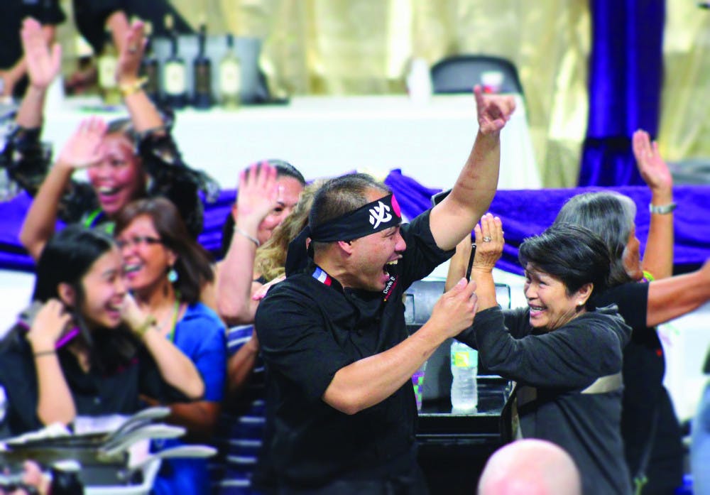 Chef Nester Espartero of Volcanic Sushi + Sake celebrates his team's Iron Chef victory at Tastes of Greater Gainesville 2018.