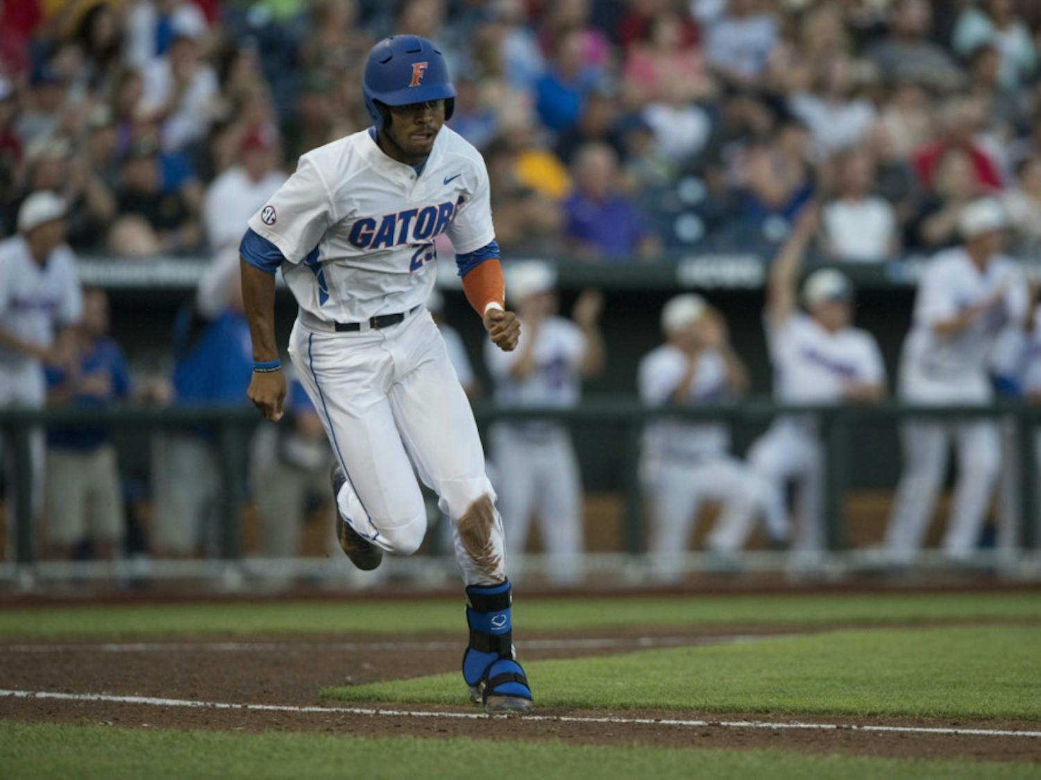 Florida's Buddy Reed runs toward first base during the Gators' 15-3 victory against Miami in the NCAA Men's College World Series on Saturday, June 13, 2015 at TD Ameritrade Park in Omaha.
