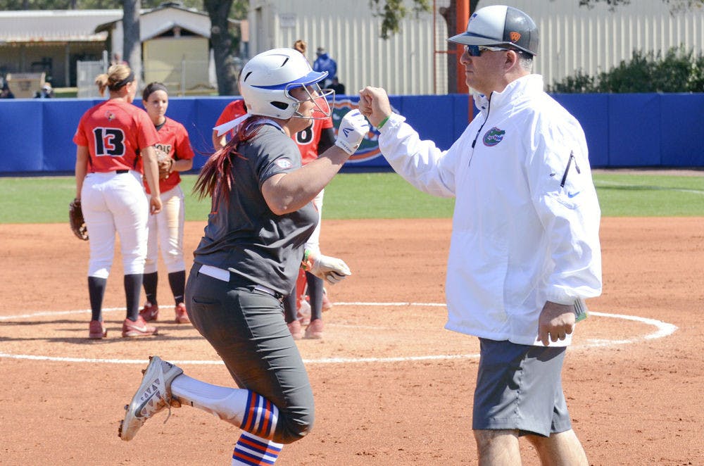 <p>UF's Lauren Haeger fist bumps coach Tim Walton after hitting a home run during Florida's 4-1 win against Illinois State on Feb. 21 at Katie Seashole Pressly Stadium.</p>