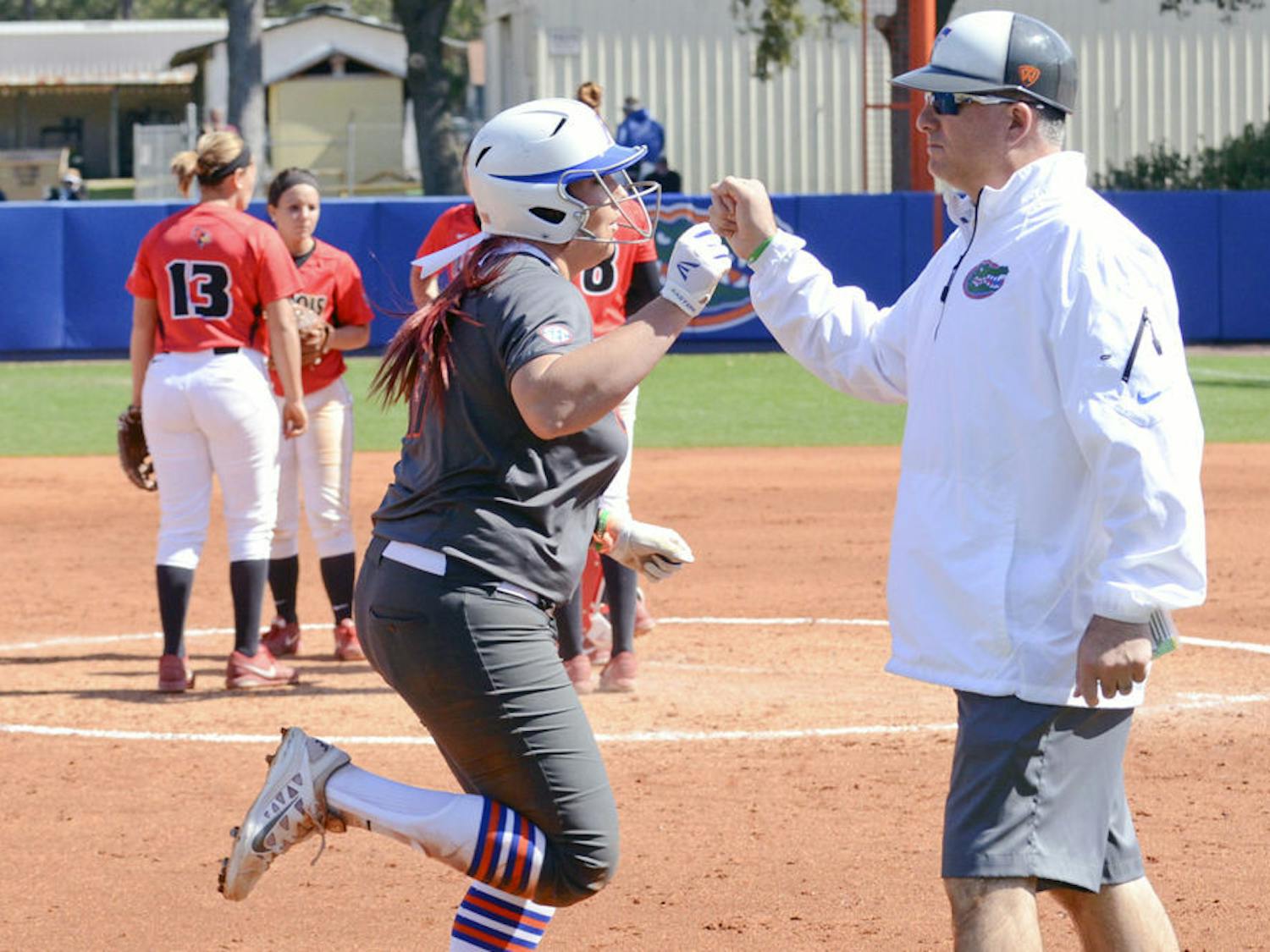 UF's Lauren Haeger fist bumps coach Tim Walton after hitting a home run during Florida's 4-1 win against Illinois State on Feb. 21 at Katie Seashole Pressly Stadium.