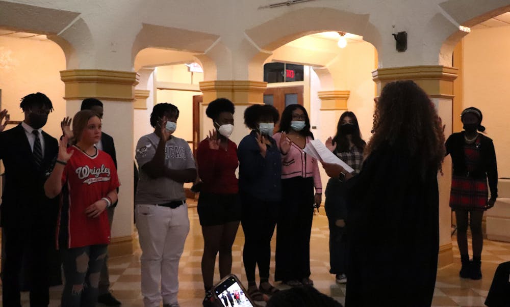 Judge Gloria Walker of the Eighth Judicial Circuit leads the first-ever Alachua County Youth Activities Advisory Council members in an oath at the council's induction at the Thomas Center on Monday, Feb. 21.