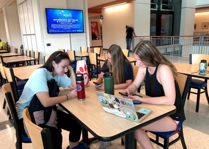 




Isabella Vasquez, 18, Holly Kappes, 18, and Madison Grove, 18, check their social media accounts at the Reitz Union. All are incoming freshman.




