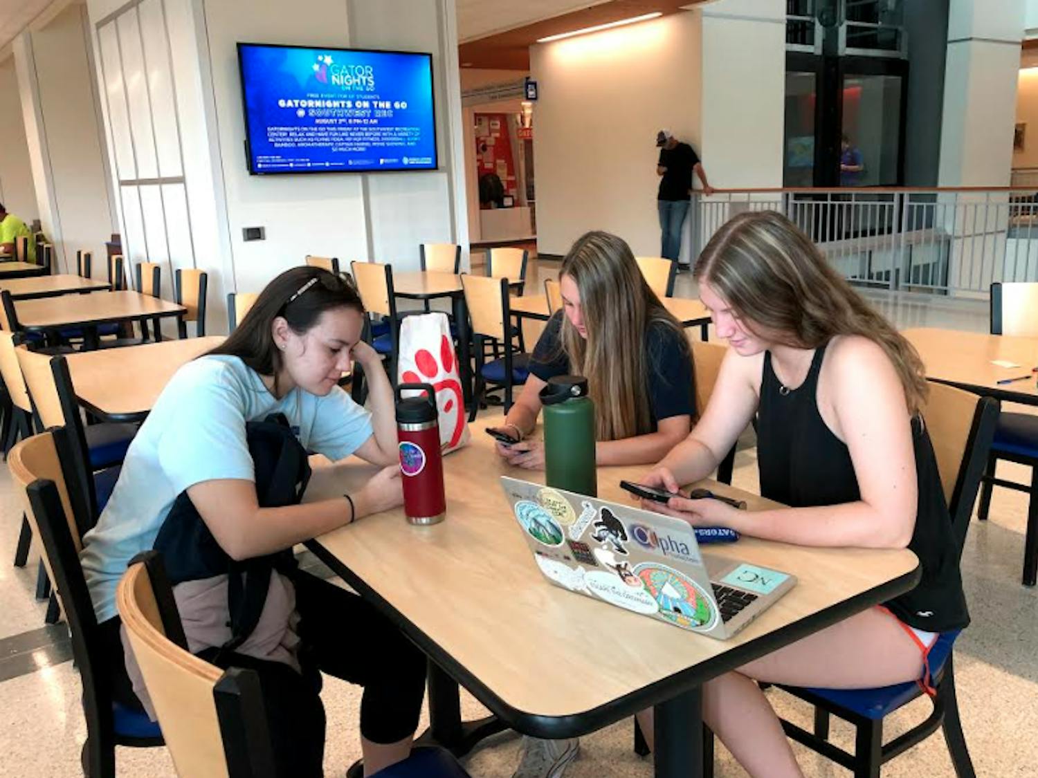 




Isabella Vasquez, 18, Holly Kappes, 18, and Madison Grove, 18, check their social media accounts at the Reitz Union. All are incoming freshman.




