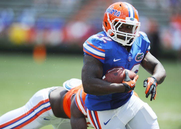 Adam Lane (22) breaks a tackle during Florida’s Orange and Blue Debut on Saturday in Ben Hill Griffin Stadium. Lane was UF’s leading rusher during the game.