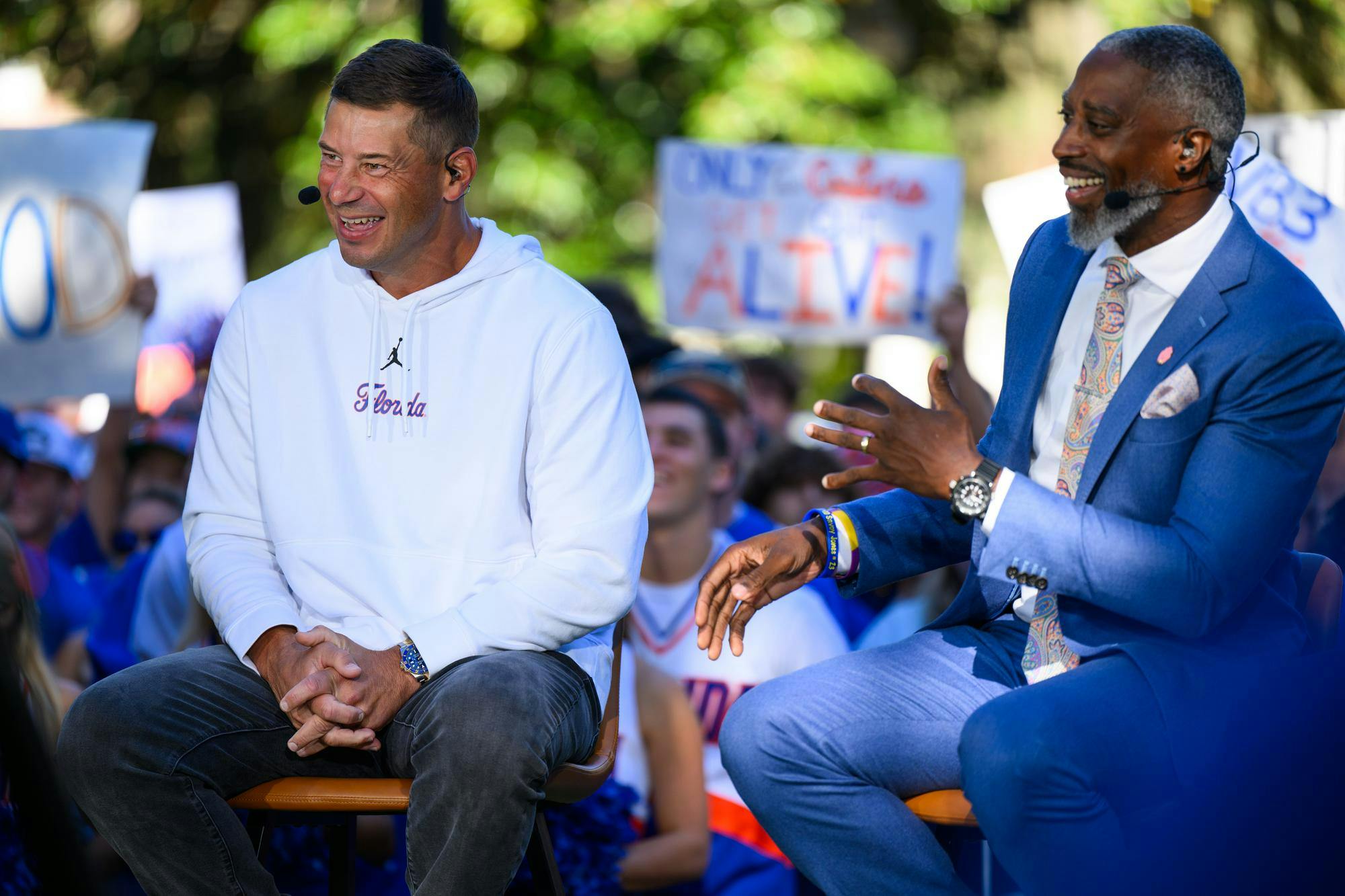 Florida head coach Jon Sumrall (left) laughs with ESPN’s Roman Harper (right) during SEC Nation’s show on Plaza of the Americas before Florida hosts Ole Miss, Saturday, Sept. 26, 2026, in Gainesville, Fla.