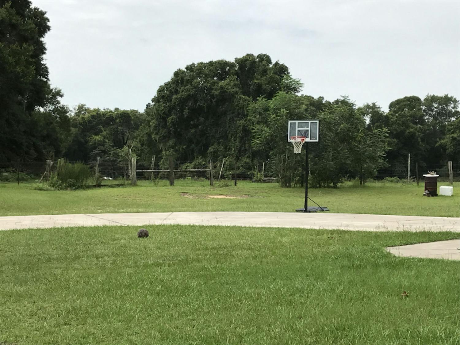The basketball court in the family’s yard isn’t used much anymore. But relatives and friends come over and play sometimes, so a ball and hoop remain.