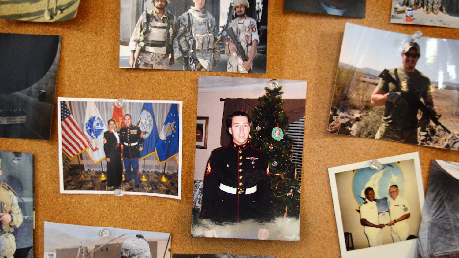 Photographs of members in uniform and in the field are displayed on the walls of the Collegiate Veterans Success Center.
