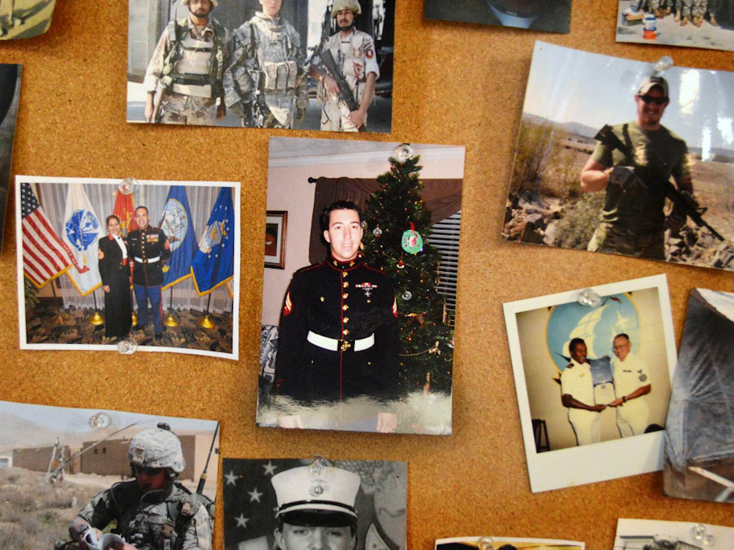 Photographs of members in uniform and in the field are displayed on the walls of the Collegiate Veterans Success Center.