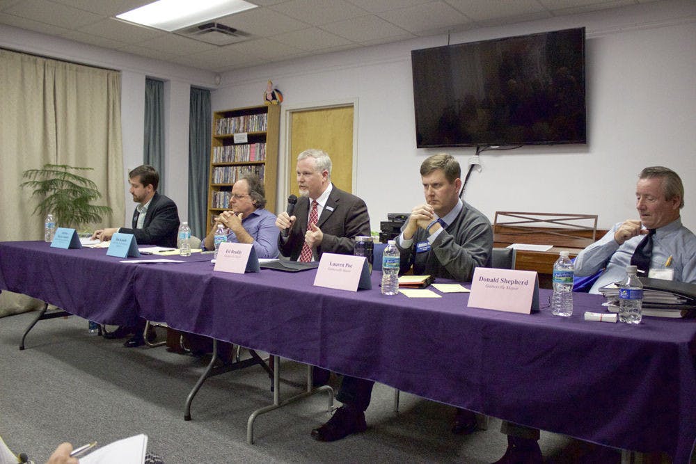 From left, Adrian Hayes-Santos, Jim Konish, Mayor Ed Braddy, Lauren Poe and Donald Shepherd Sr. participate in a city elections forum at the Pride Community Center of North Central Florida on Monday night.