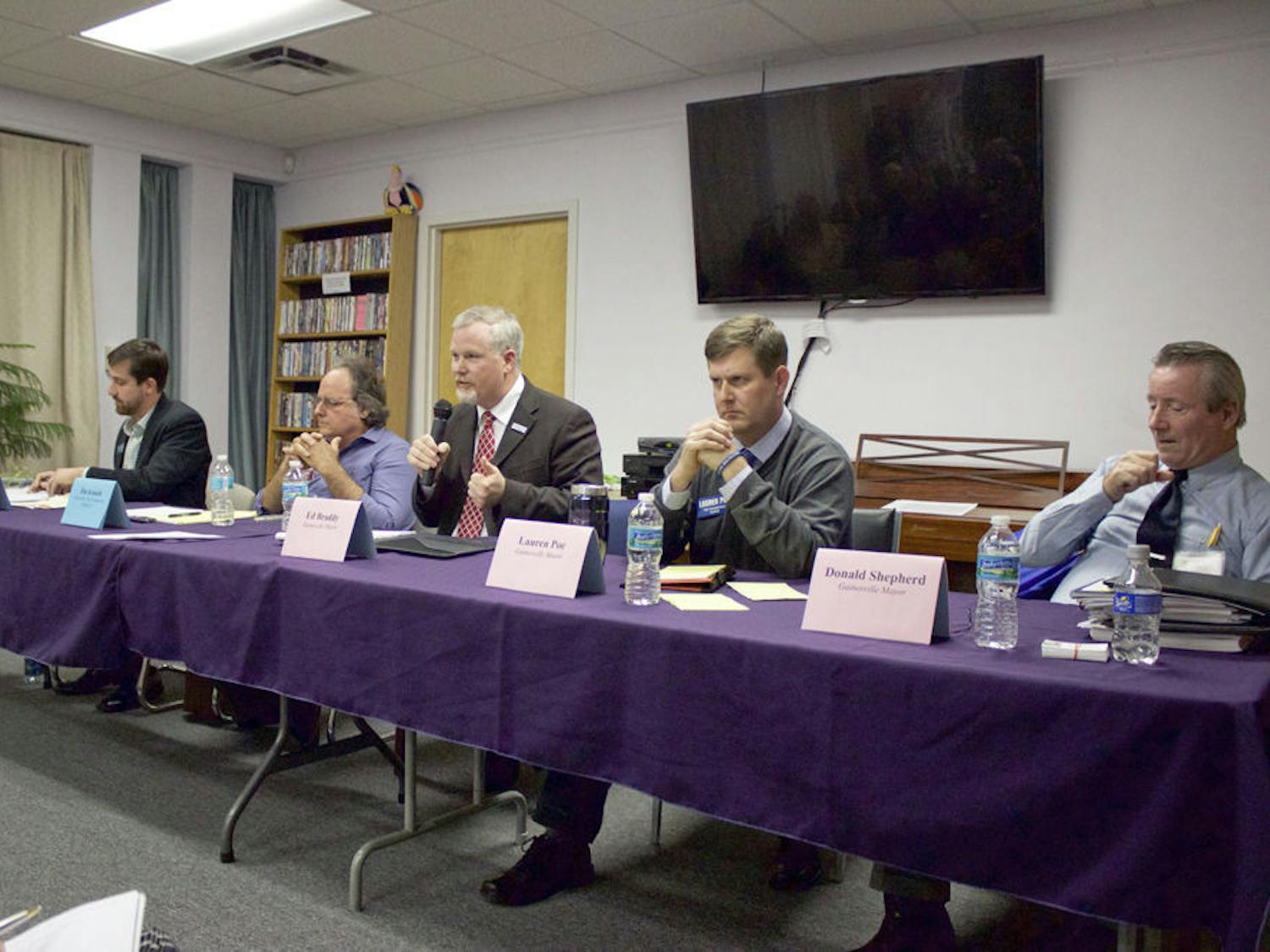 From left, Adrian Hayes-Santos, Jim Konish, Mayor Ed Braddy, Lauren Poe and Donald Shepherd Sr. participate in a city elections forum at the Pride Community Center of North Central Florida on Monday night.