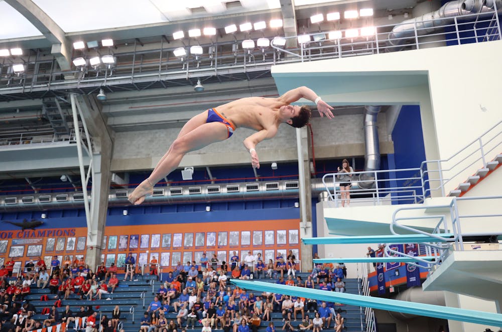 Senior diver Skip Donald begins his dive during the Gators' meet against the Georgia Bulldogs on Friday, October 27, 2023, at the Stephen C. O'Connell Center Natatorium in Gainesville, Florida.