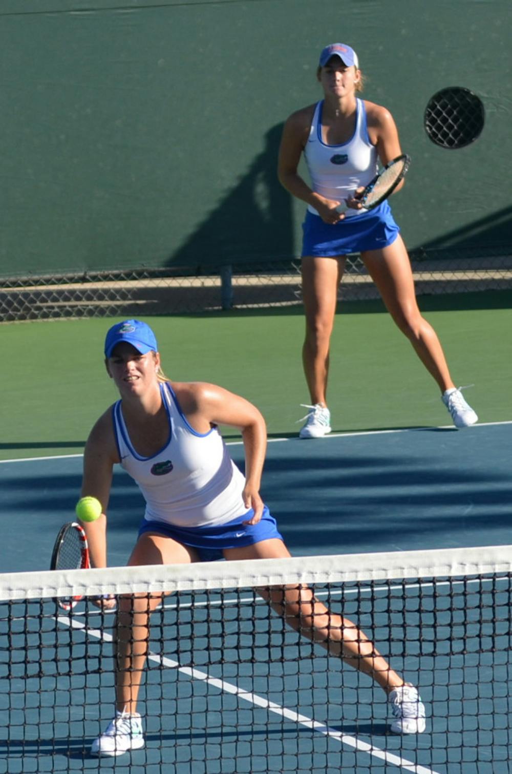 <p>Freshmen Kourtney Keegan (back) and Belinda Woolcock compete in the doubles finals of the Bedford Cup on Oct. 13 at the Ring Tennis Complex.</p>