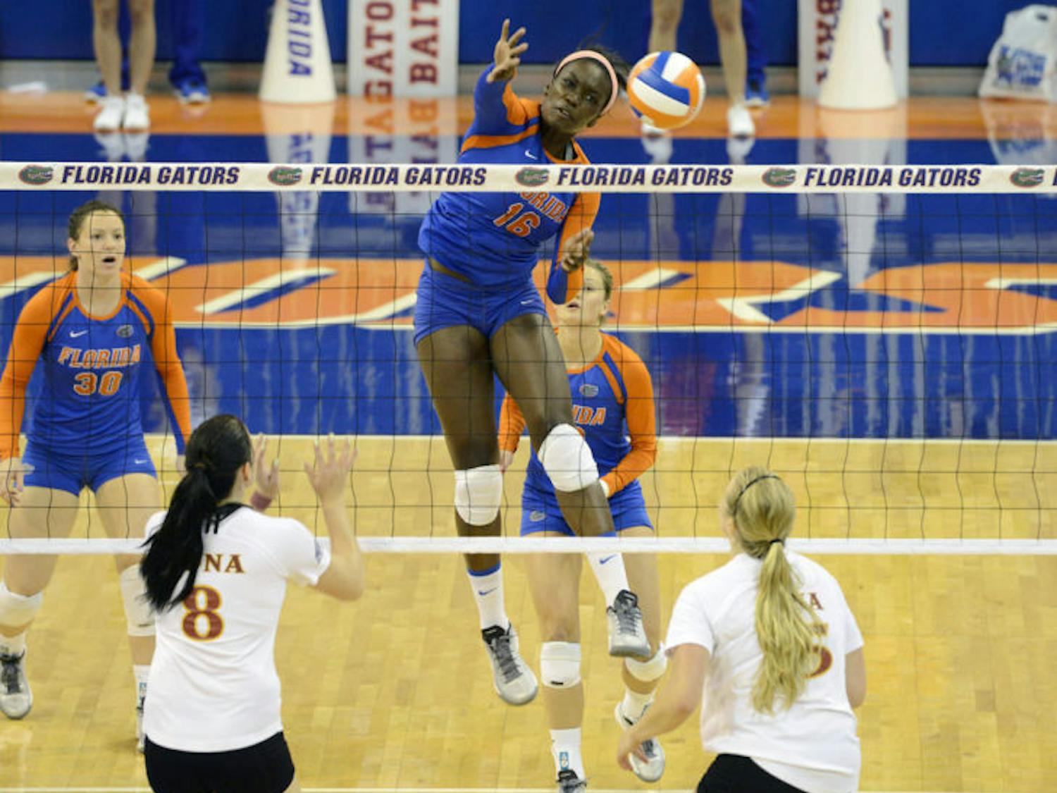 Sophomore middle blocker Simone Antwi (16) jumps to block the ball during Florida’s three-set win against Iona on Sept. 14 in the O’Connell Center.