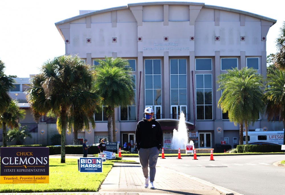 Dominic Bouton, 20, a UF applied physiology and kinesiology junior, leaves the Curtis M. Phillips Center for the Performing Arts after voting on Tuesday, Nov. 3, 2020. (Lauren Witte/Alligator Staff)