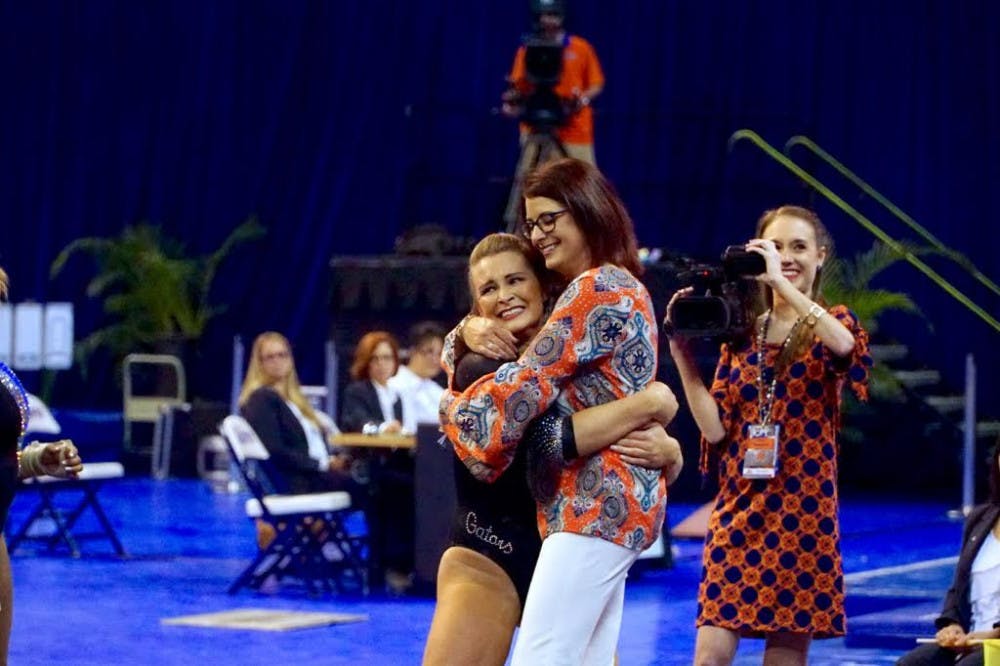 Bridget Sloan celebrates with coach Jenny Rowland during Florida's&nbsp;198.050-193.725 win over North Carolina on March 11, 2016, in the O'Connell Center.&nbsp;
