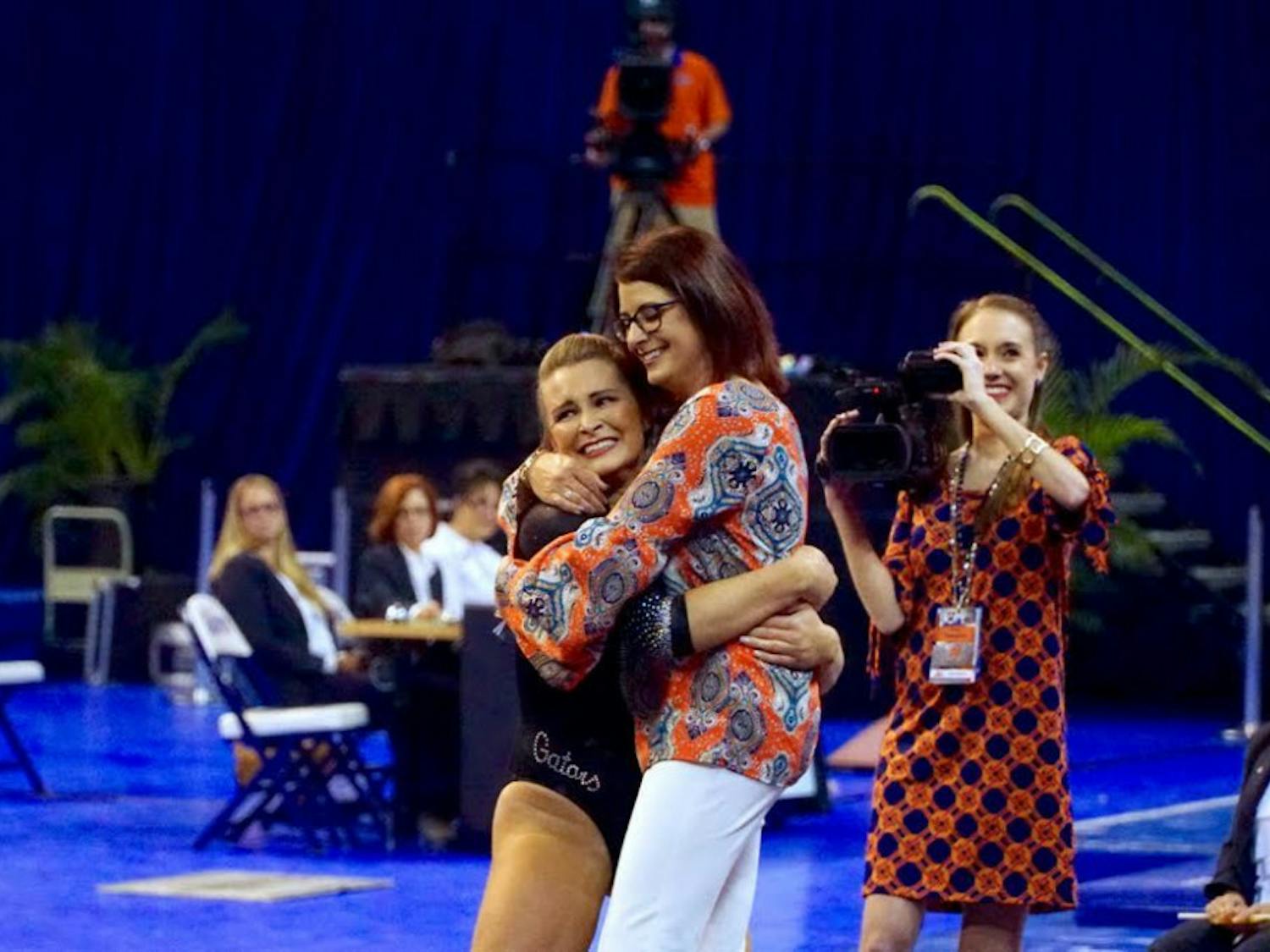 Bridget Sloan celebrates with coach Jenny Rowland during Florida's&nbsp;198.050-193.725 win over North Carolina on March 11, 2016, in the O'Connell Center.&nbsp;