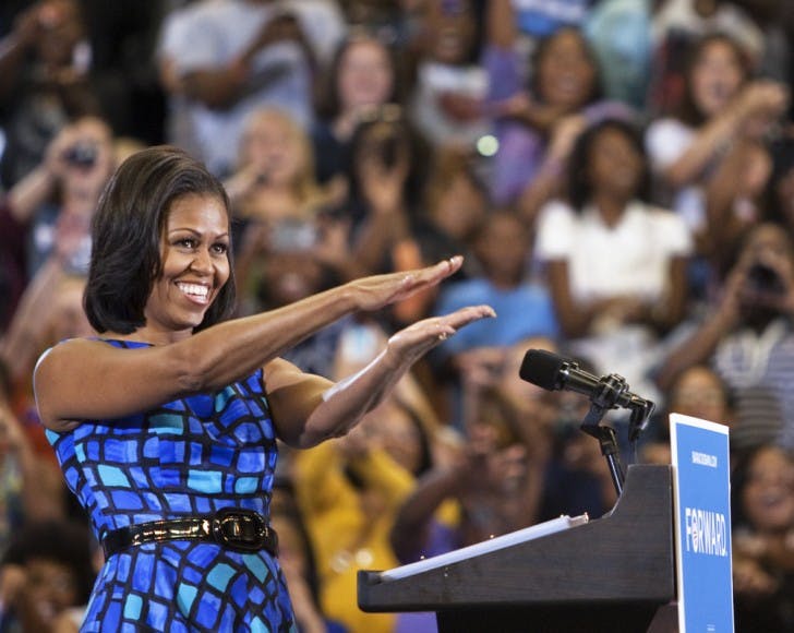 First lady Michelle Obama does the Gator chomp after arriving at the lectern in front of about 11,000 people Monday afternoon at the Stephen C. O’Connell Center.