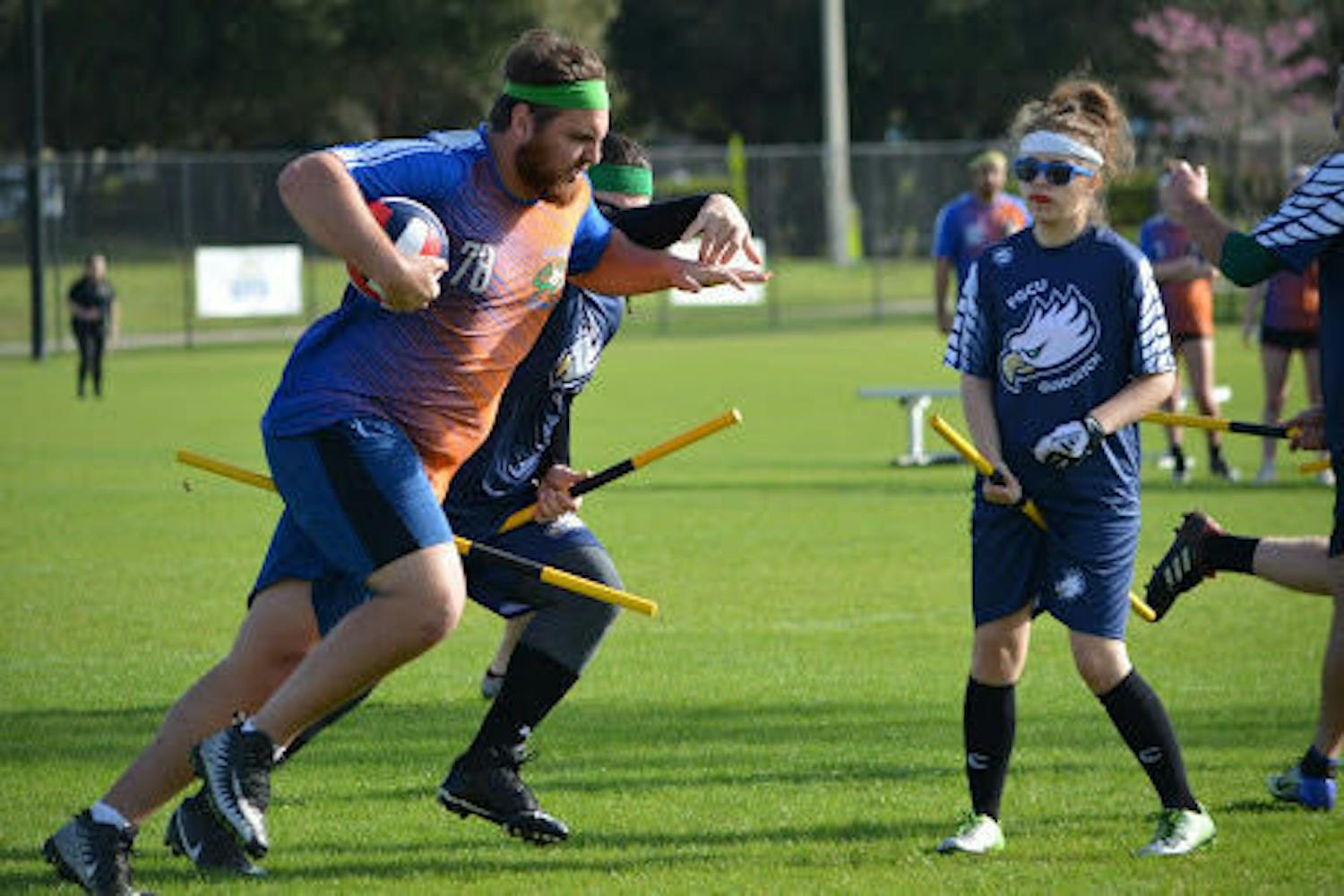 Team captain of the UF Quidditch team Jeremy Kowkabany, a 21-year-old UF astrophysics junior, runs across the field with the ball.