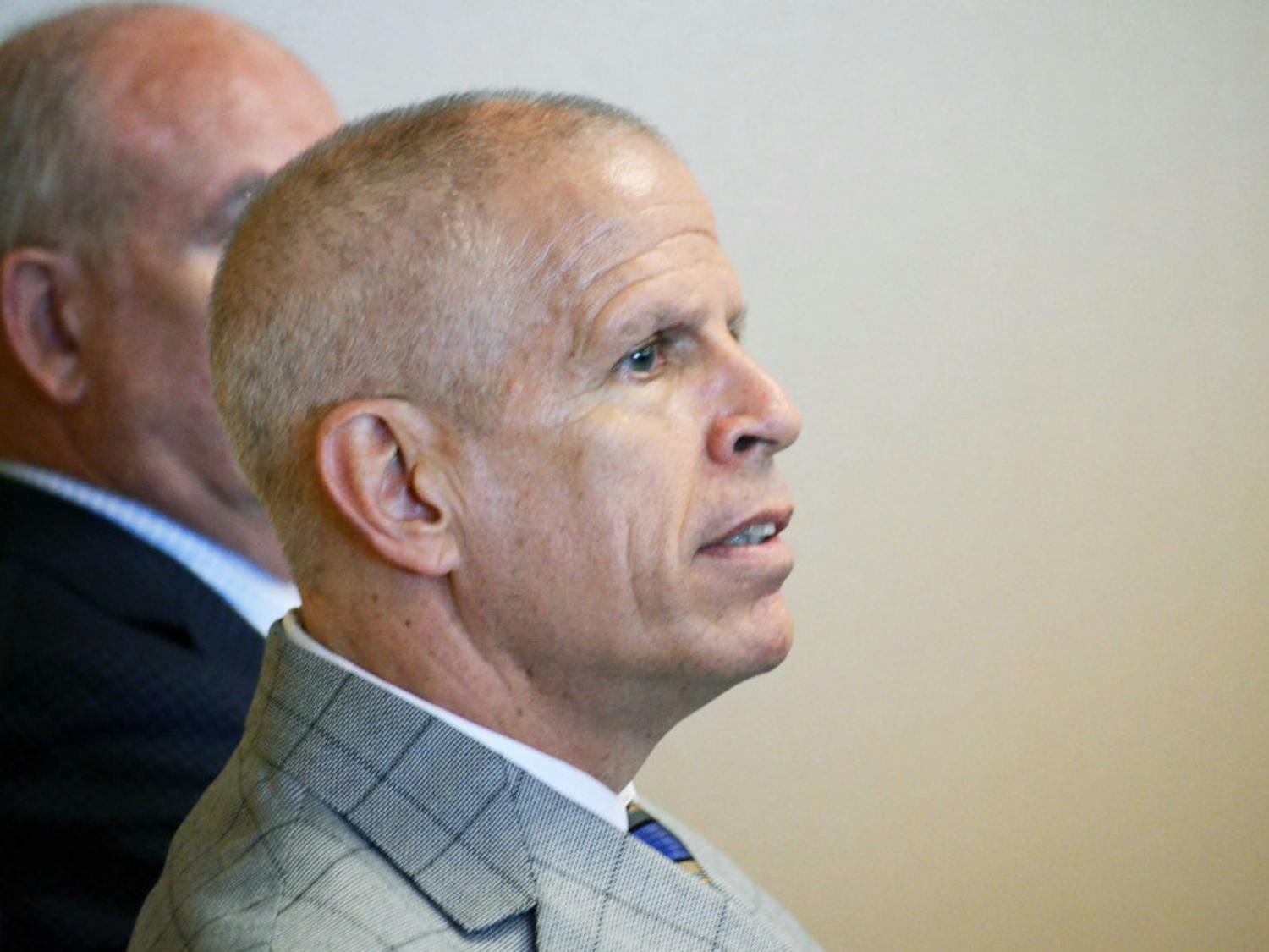 UF athletics director Jeremy Foley listens as Jim McElwain gives his press conference on Dec. 6, 2014, at Ben Hill Griffin Stadium.
