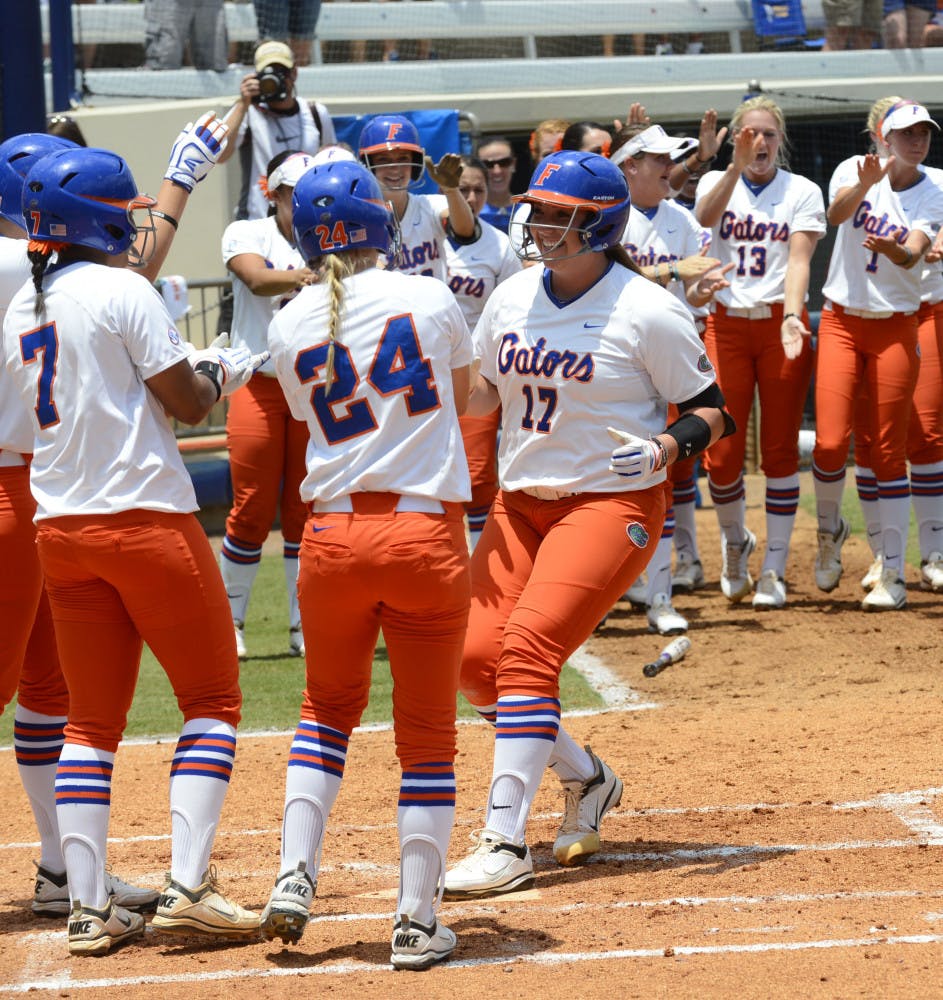 Sophomore Lauren Haeger (17) joins her teammates at home plate after a three-RBI blast during Florida’s 11-1 win against USF on Saturday at Katie Seashole Pressly Stadium. Against the Bulls, Haeger racked up seven RBI – tying a single-game UF record.