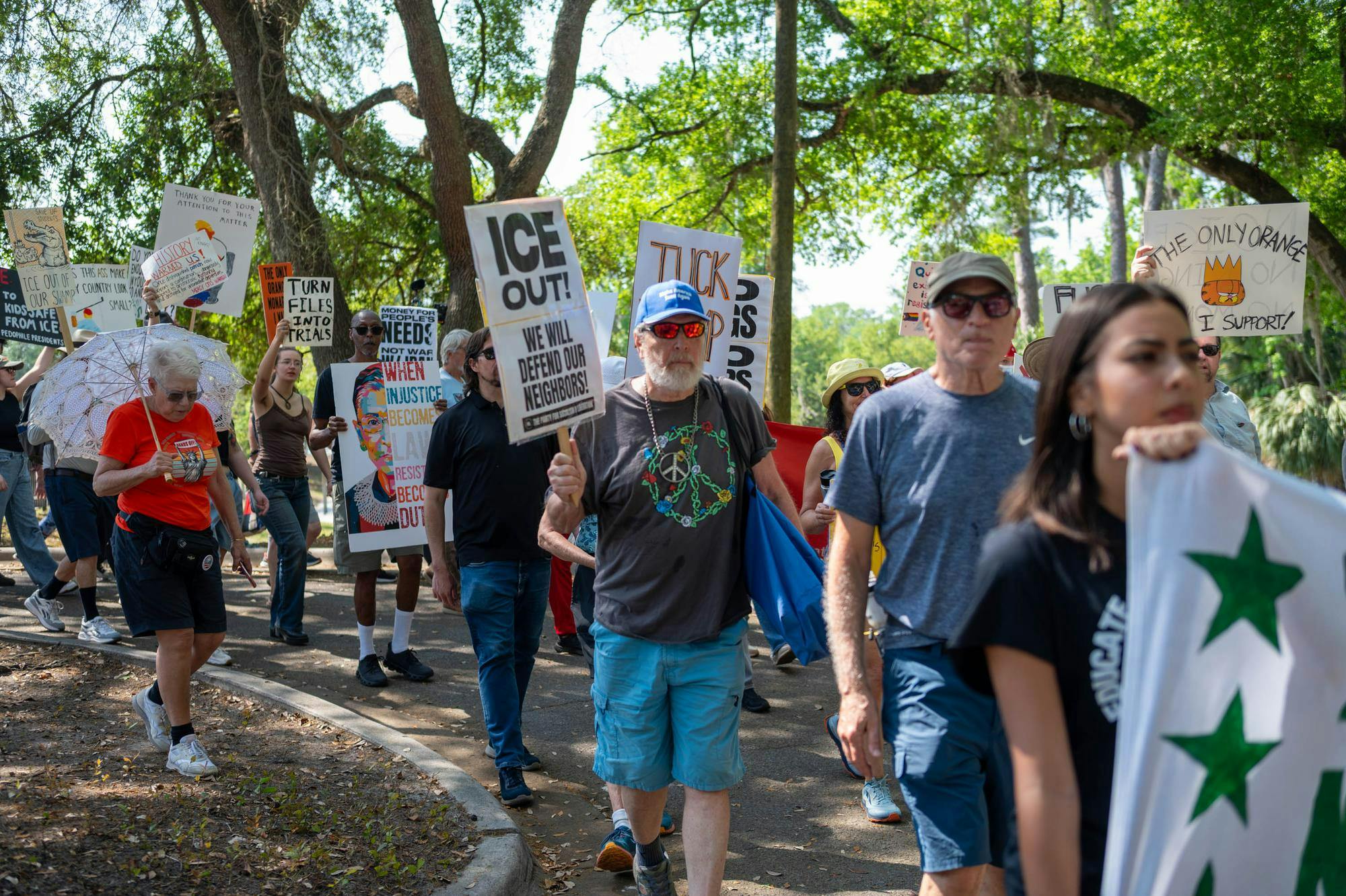 Protestors march down Depot Avenue, Saturday, March 28, 2026, in Gainesville, Fla.
