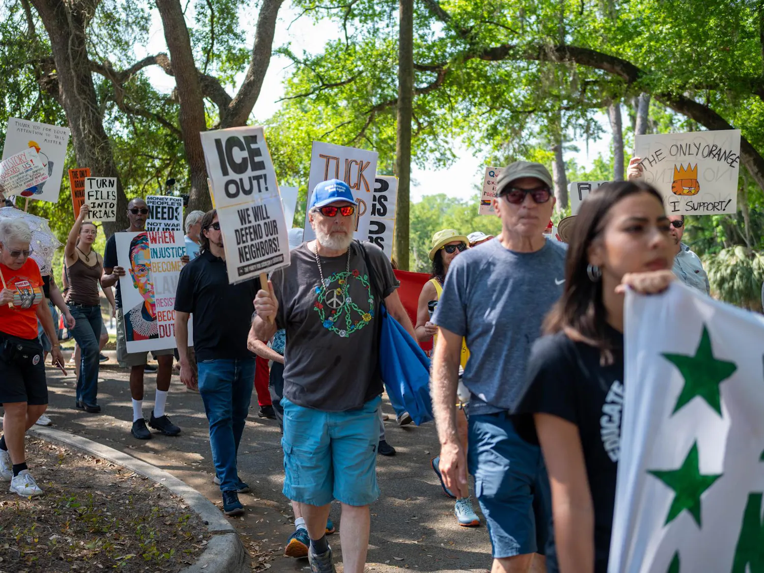 Protestors march down Depot Avenue, Saturday, March 28, 2026, in Gainesville, Fla.