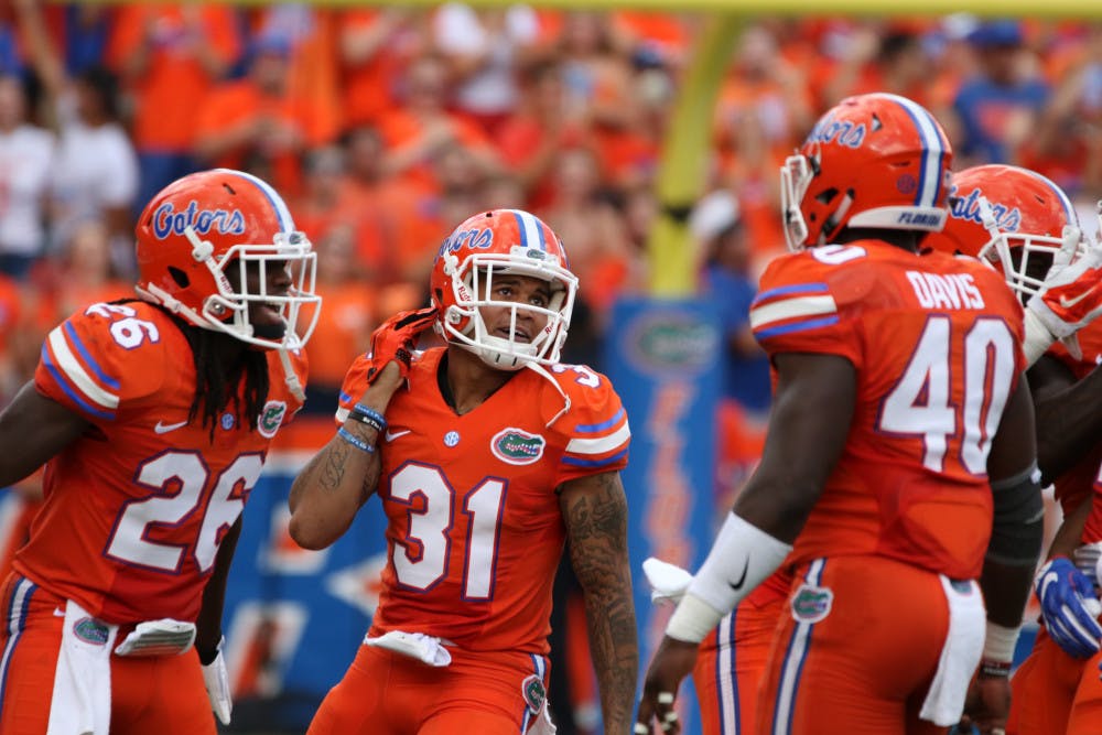 Jalen tabor (31) celebrates with teammates after intercepting a pass during Florida's 45-7 win over Kentucky on Sept. 10, 2016, at Ben Hill Griffin Stadium.