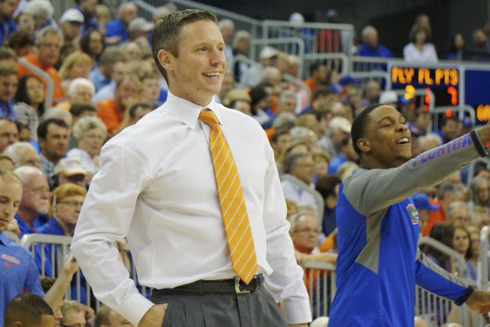 <p>UF men's basketball coach Mike White smiles after a play during Florida's 104-54 win against North Carolina A&amp;T on Nov. 16, 2015, in the O'Connell Center.</p>