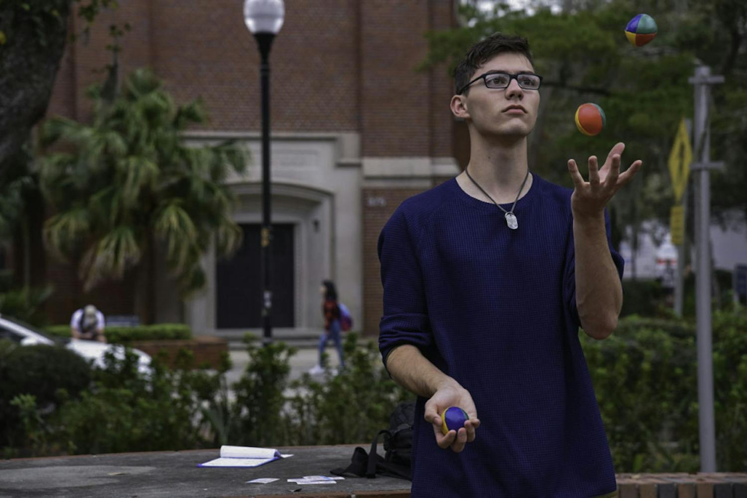 Ethan Irvin, a 19-year-old UF mathematics sophomore, juggles on Turlington Plaza on Feb. 12. Irvin said he's been juggling for more than two years and loves doing it. "It's a good stress reliever,” he said.