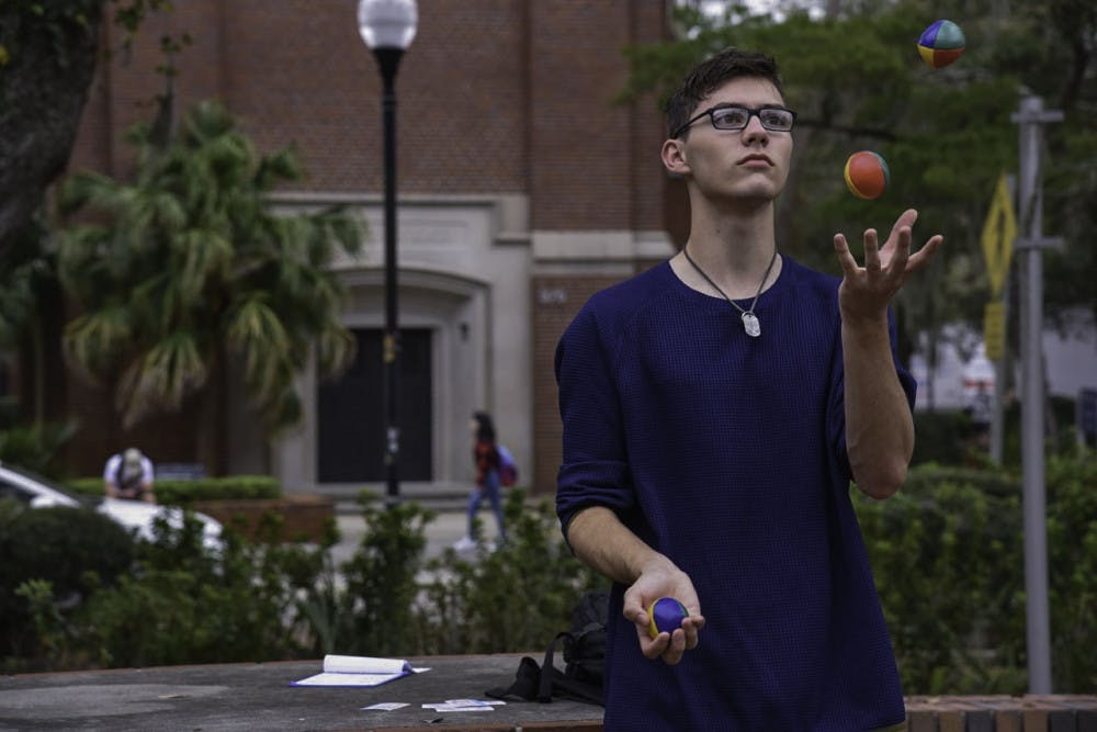 <p><span id="docs-internal-guid-66c66342-7fff-98d9-a2e7-b7ef91832347"><span>Ethan Irvin, a 19-year-old UF mathematics sophomore, juggles on Turlington Plaza on Feb. 12. Irvin said he's been juggling for more than two years and loves doing it. "It's a good stress reliever,” he said.</span></span></p>