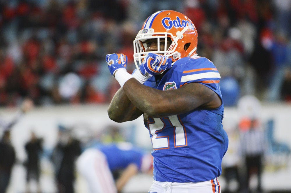 <p>Kelvin Taylor celebrates during Florida's 38-20 win against Georgia on Saturday at EverBank Field in Jacksonville.</p>
