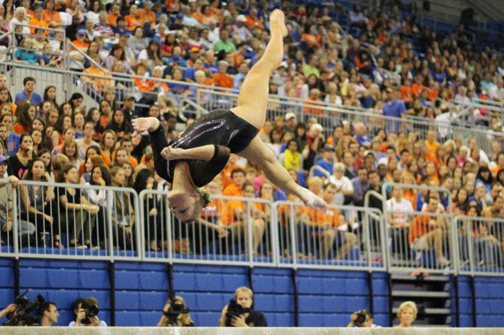 Freshman gymnast Bridget Sloan&nbsp; performs a flip on the balance beam during Florida’s 196.975-196.075 win against Kentucky on Feb. 22 in the O’Connell Center.