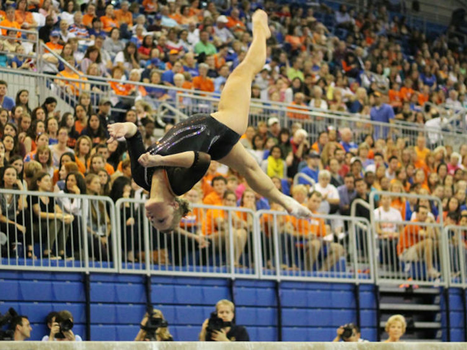 Freshman gymnast Bridget Sloan&nbsp; performs a flip on the balance beam during Florida’s 196.975-196.075 win against Kentucky on Feb. 22 in the O’Connell Center.